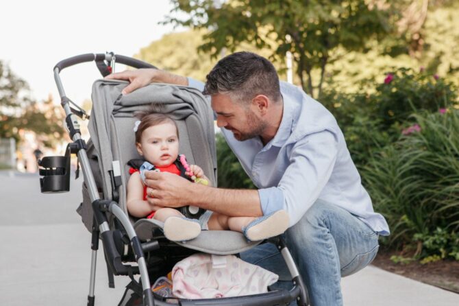 Photo_of_a_man_and_a_baby_in_a_stroller_in_a_park